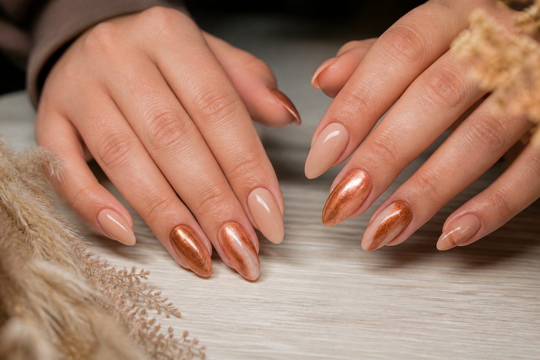 Close-up of a nude almond builder-gel set on anonymous hands — example mood for Lumen Nails.